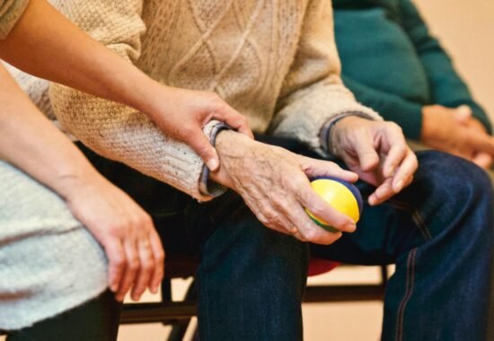 Older person holding someone's hand